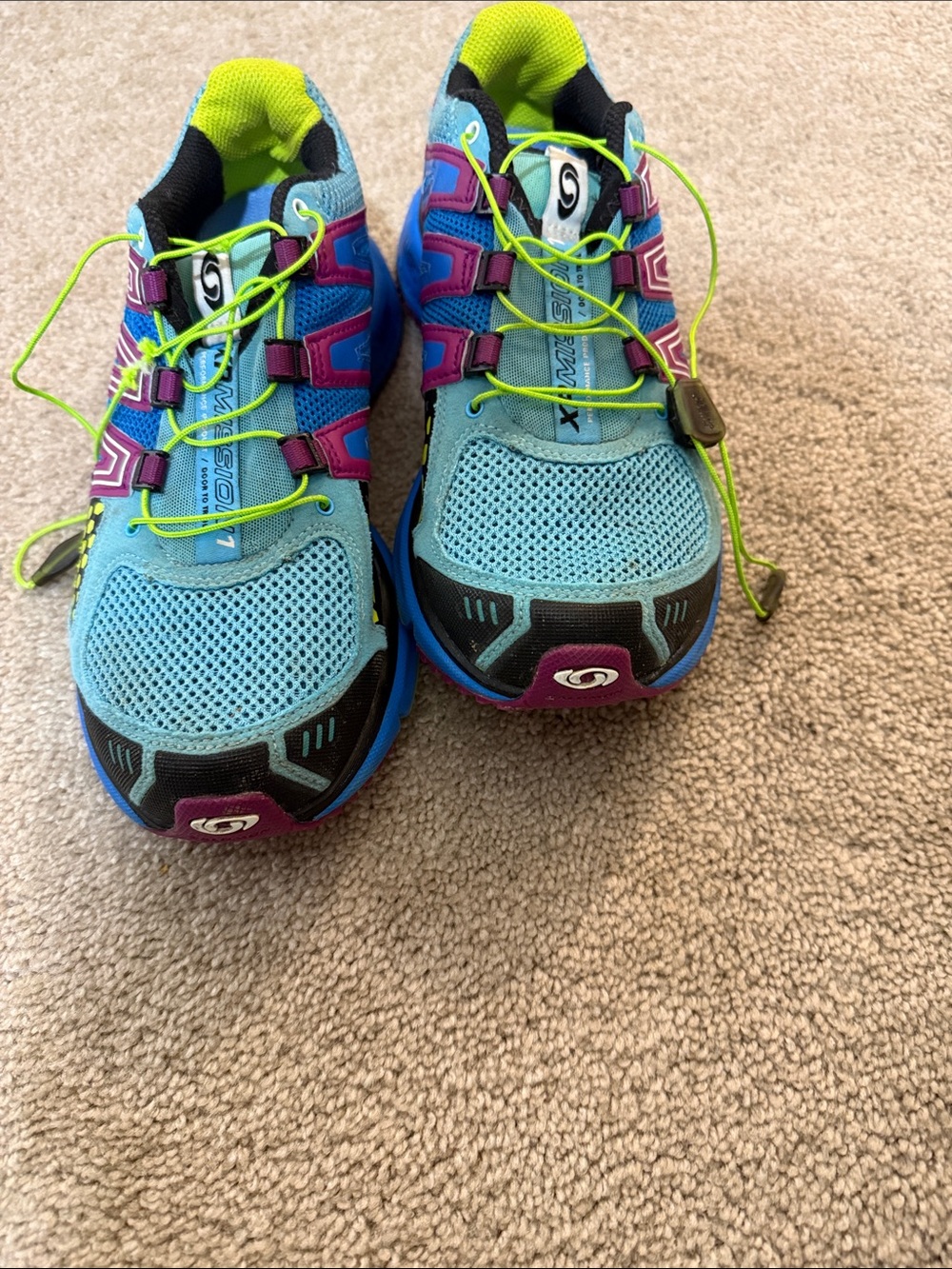 Salomon women’s Light Blue Sneakers with Neon Green Laces and Purple Accents